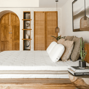 Heveya II natural latex mattress displayed in a modern bed frame, showcasing its plush, organic design.