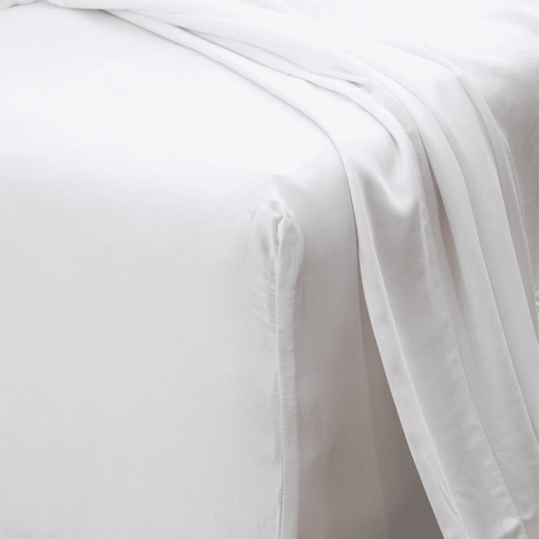 Soft, breathable bamboo fitted sheet set in white, creating a cool and comfortable sleeping surface.