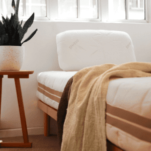 Latex mattress supported by a slatted bed base for optimal spinal alignment, pressure relief, and enhanced breathability.