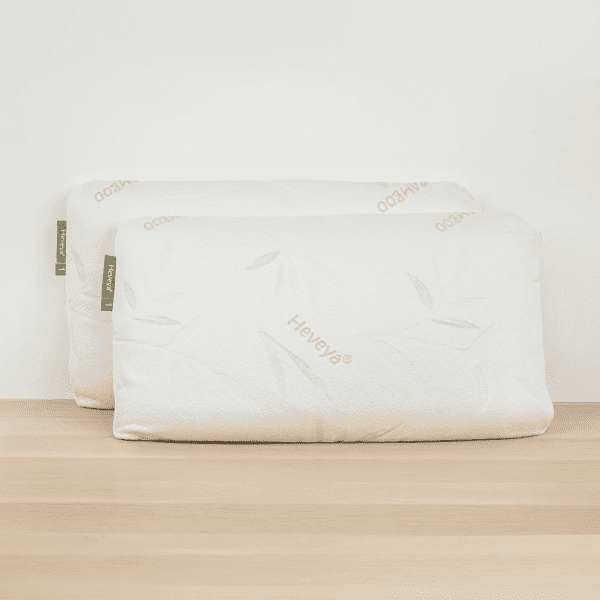 2 Close-up view of a soft, thin Heveya organic latex pillow against a white background. Perfect for breathable and pressure-relieving sleep. This pillow is ideal for stomach and back sleepers.