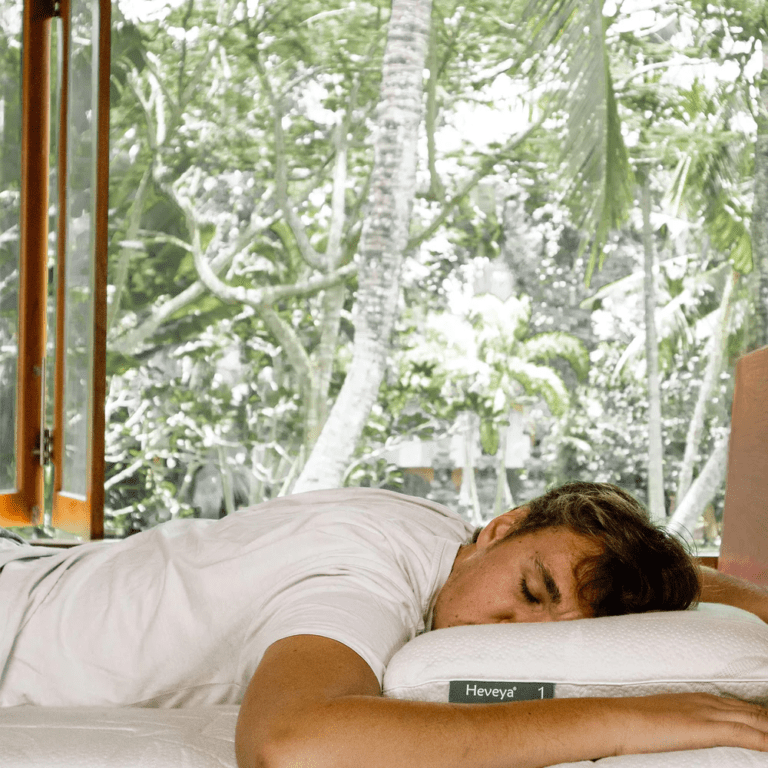 Man enjoying a comfortable sleep on his stomach on a soft, thin Heveya organic latex pillow. Conforms to the body's natural curves for pressure point relief.