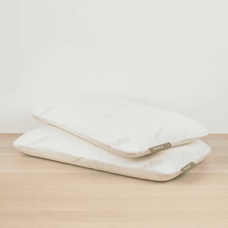 Another view of a soft, thin Heveya organic latex pillow on a white background. Crafted from natural, hypoallergenic latex for a healthy sleep experience. This thin profile pillow is suitable for stomach and back sleepers.