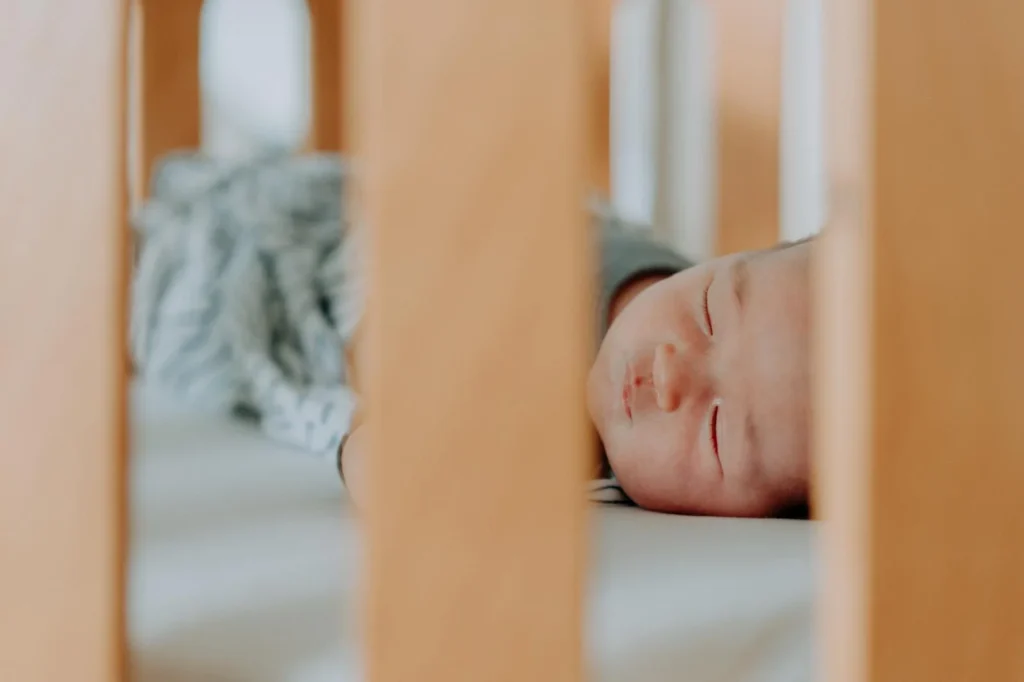 Baby sleeping on a Heveya® Junior Cot Natural Organic Latex Mattress