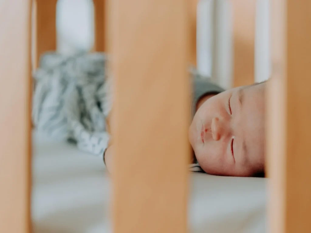 Baby sleeping on a Heveya® Junior Cot Natural Organic Latex Mattress