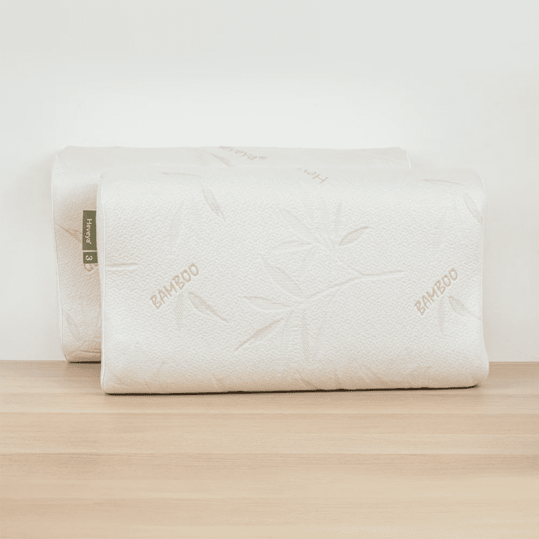 Close-up view of the Heveya Contoured Organic Latex Pillow. This breathable, eco-friendly pillow features a contoured design for optimal spinal alignment.