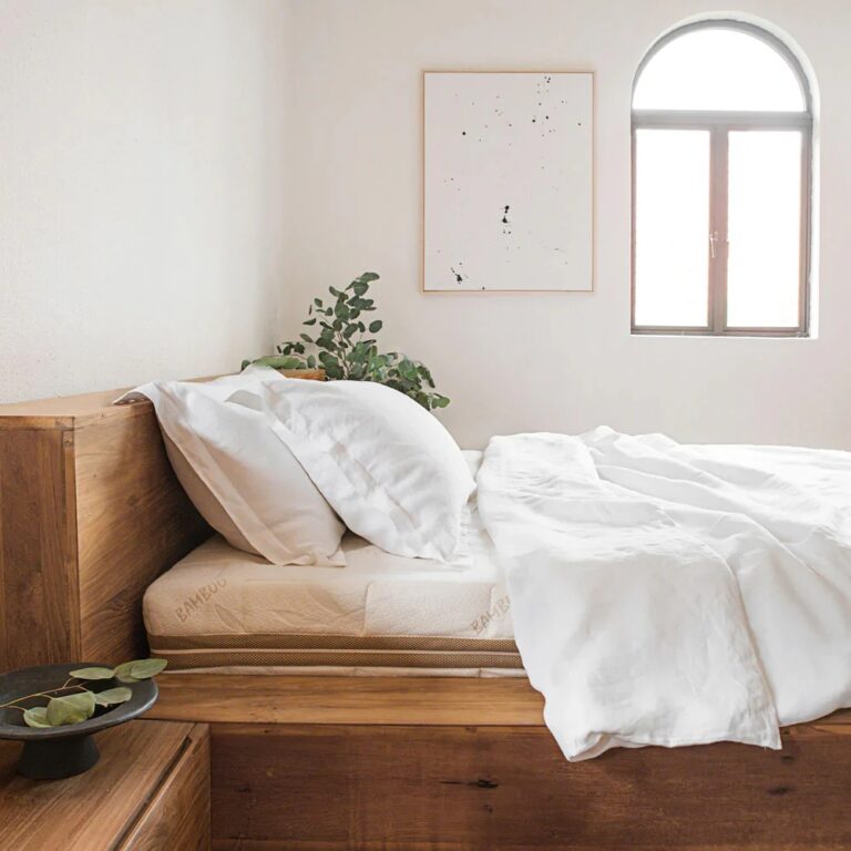 Linen Duvet Cover Set in white resting on a wooden bed