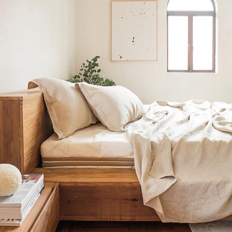 Heveya Linen Flat Sheet Set resting on a bed.