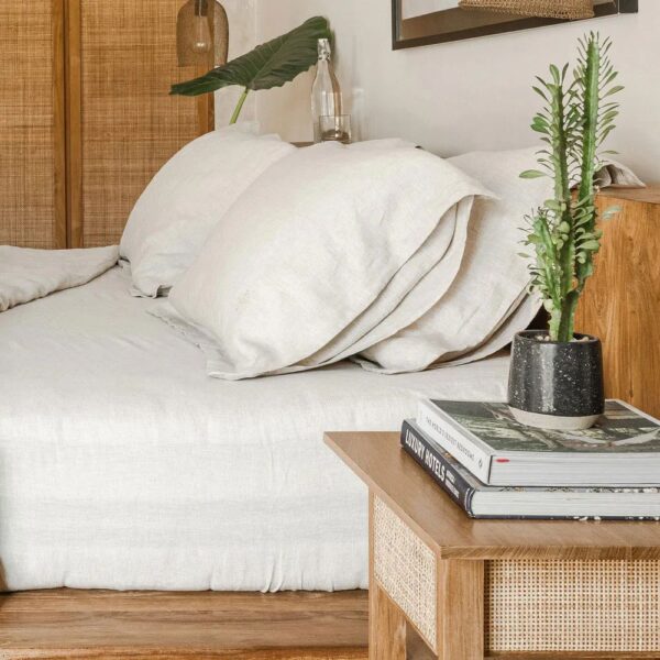 Linen Fitted Sheet Set resting on a wooden bed
